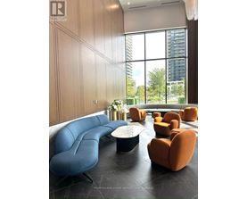 A living room with a blue and orange sofa.