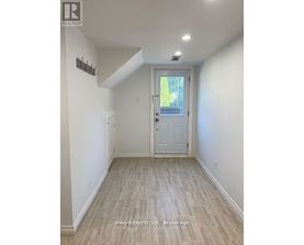 A hallway with a white door and a small window.