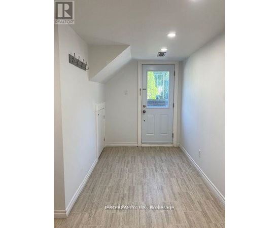 A hallway with a white door and a small window.