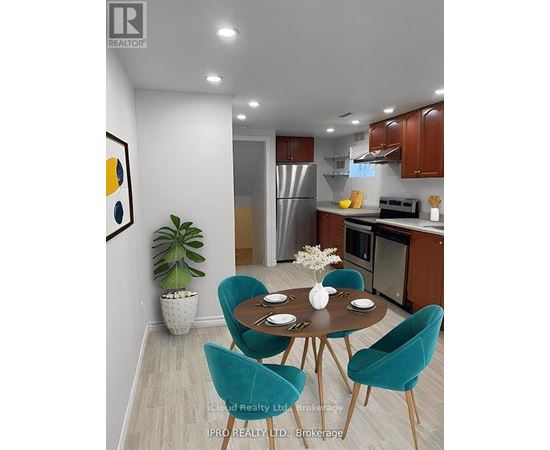 A modern kitchen with a dining table set for two.