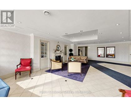 A spacious living room with a red chair and a blue sofa.
