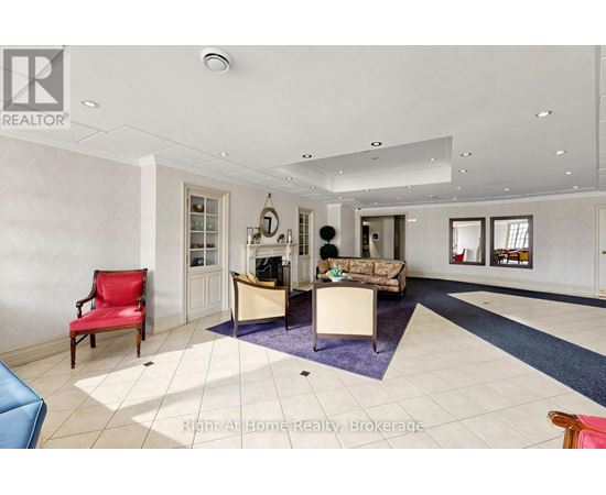 A spacious living room with a red chair and a blue sofa.