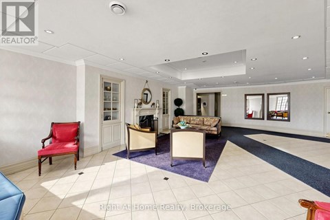 A spacious living room with a red chair and a blue sofa.