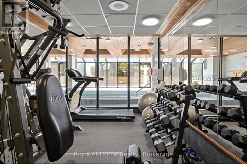 A gym with a variety of equipment including a weight bench, a treadmill, and a rowing machine.