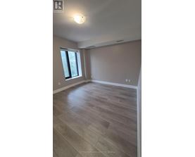 A room with wooden flooring and a window.