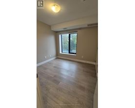 A room with a window and wooden flooring.