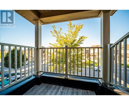 A balcony with a view of a street and houses.