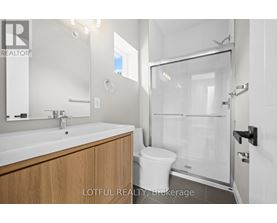 A bathroom with a sink, toilet and shower.