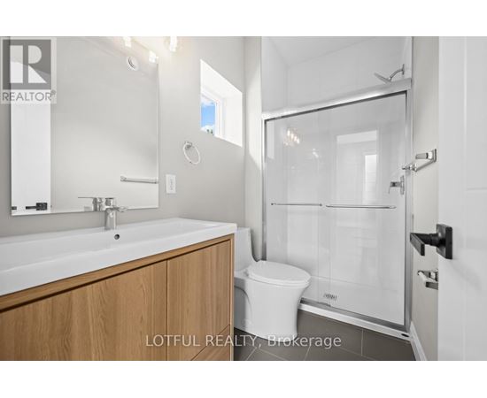 A bathroom with a sink, toilet and shower.