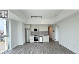 A modern kitchen with white cabinets and stainless steel appliances.