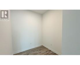 A room with a wooden floor and white walls.