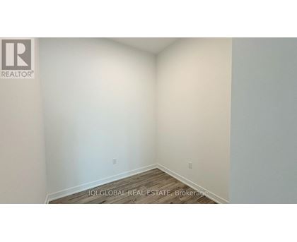 A room with a wooden floor and white walls.