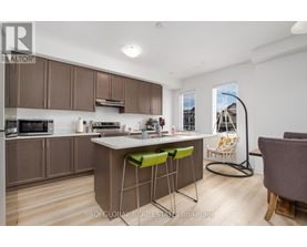 A kitchen with brown cabinets and a white island with green stools.