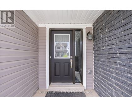 A house entrance with a black door and a glass window.