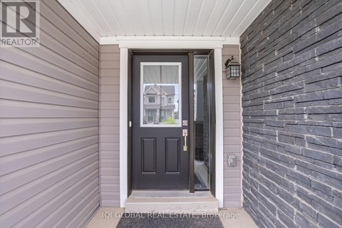 A house entrance with a black door and a glass window.