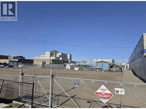 A construction site with a sign that reads "SECURITY" is fenced off.