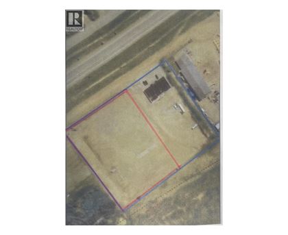 An aerial view of a property with a red line indicating a boundary.
