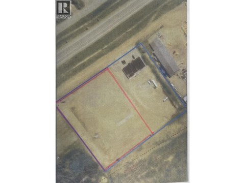 An aerial view of a property with a red line indicating a boundary.