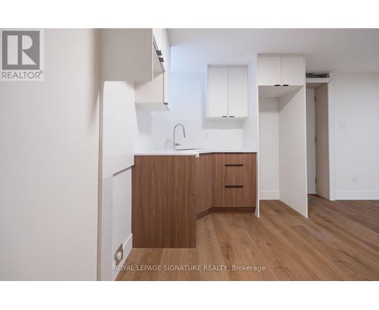 A kitchen with wooden cabinets and a sink.