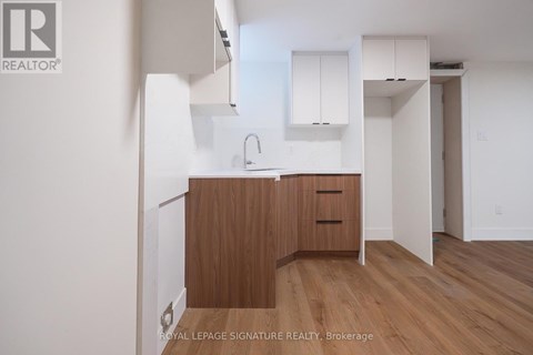A kitchen with wooden cabinets and a sink.