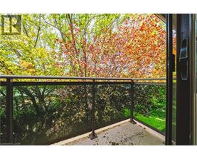 A balcony with a view of trees with autumn leaves.