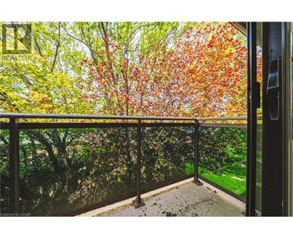 A balcony with a view of trees with autumn leaves.