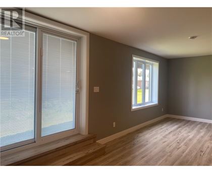 A room with a window and a sliding glass door.