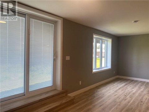 A room with a window and a sliding glass door.