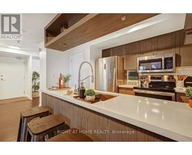 A modern kitchen with wooden cabinets and stainless steel appliances.