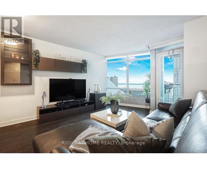 A living room with a leather couch and a flat screen TV.