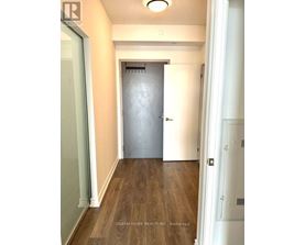 A hallway with a door at the end.