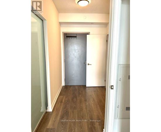 A hallway with a door at the end.