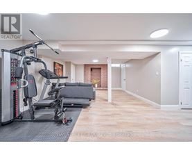 A spacious room with a gym setup and a door on the right.