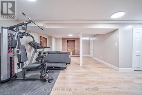 A spacious room with a gym setup and a door on the right.