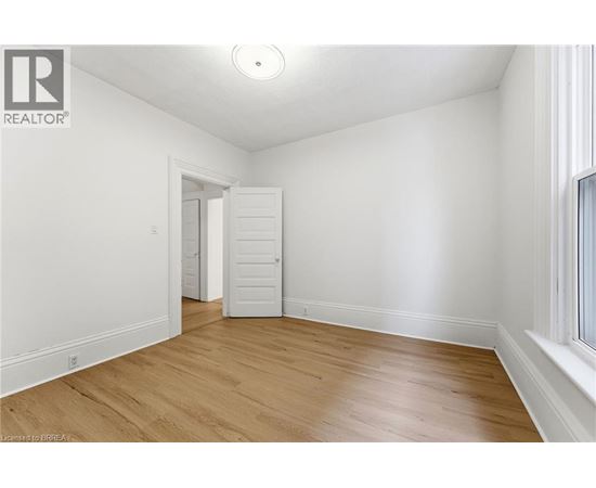 A room with wooden floors and white walls.
