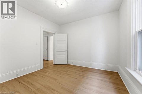 A room with wooden floors and white walls.