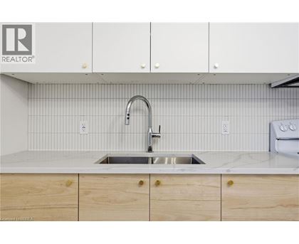 A kitchen with a sink and cabinets.