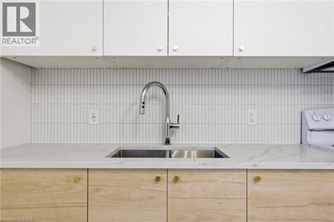 A kitchen with a sink and cabinets.