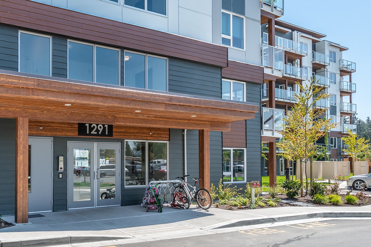 The front of apartment building number 1291 with a bicycle parked in front.