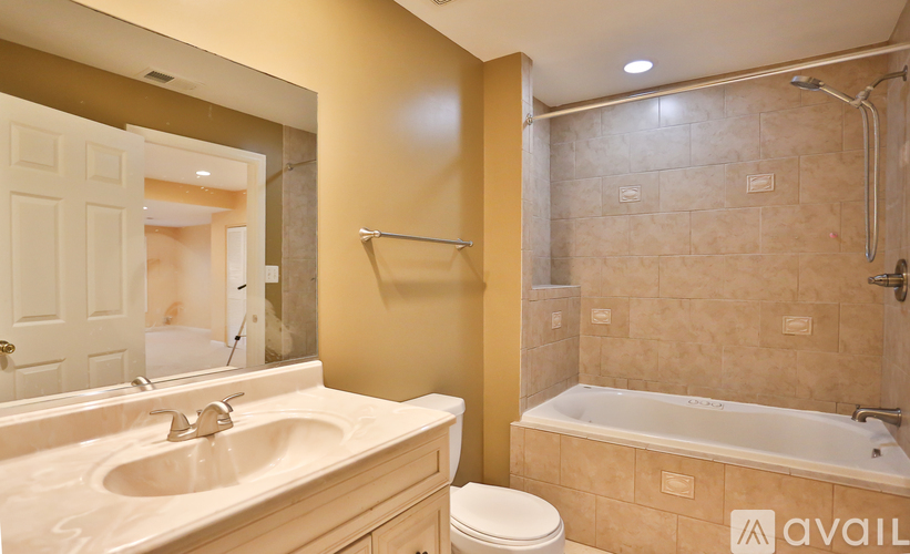 A bathroom with a sink, toilet, and bathtub.
