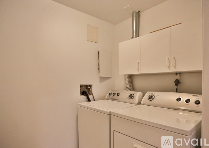 A white washing machine and dryer in a small laundry room.