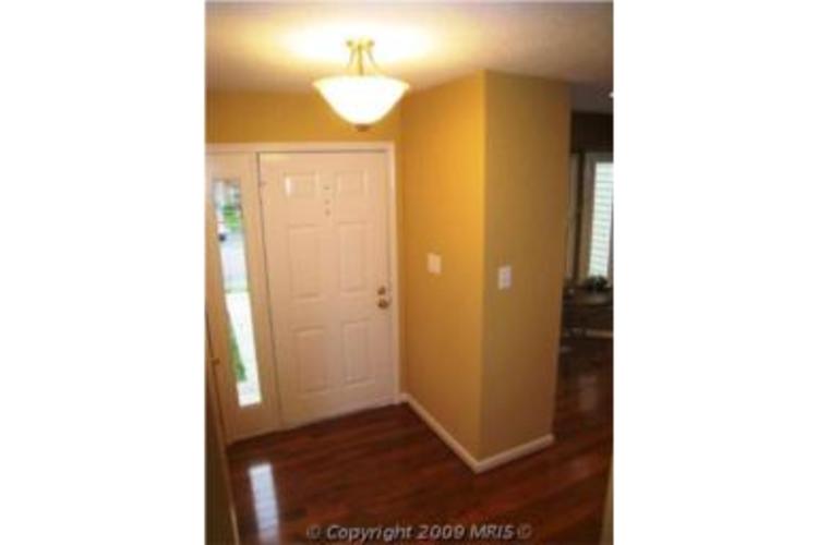 A white door is in a room with yellow walls.