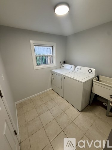 A bathroom with a window and a sink.