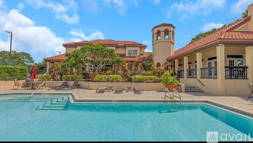 A large house with a pool in front.
