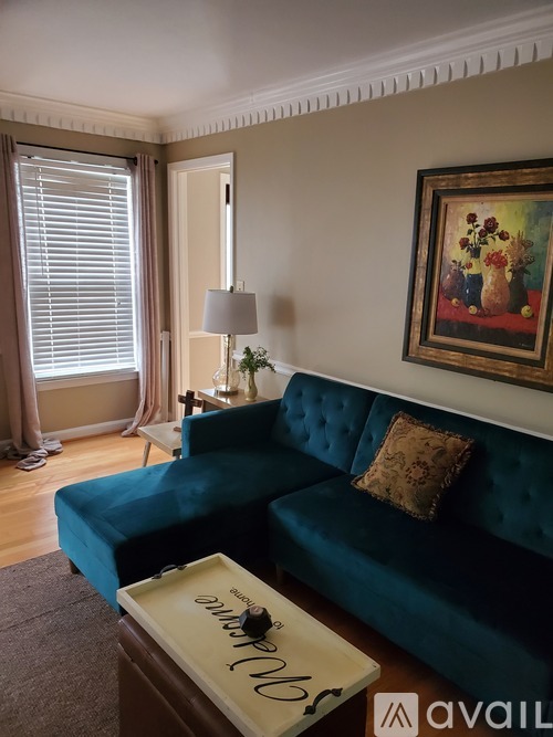A blue couch with a tray on top of it in a living room.