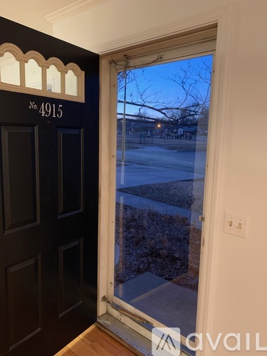 A black door with a number 4915 on it.