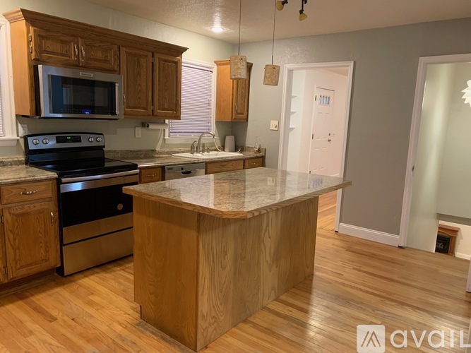 A kitchen with wooden cabinets and a granite countertop.