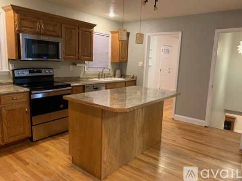 A kitchen with wooden cabinets and a granite countertop.