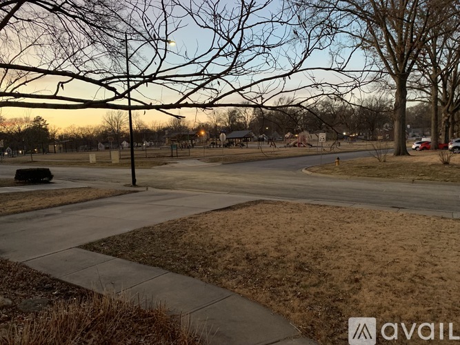 A park with a walking path and trees.