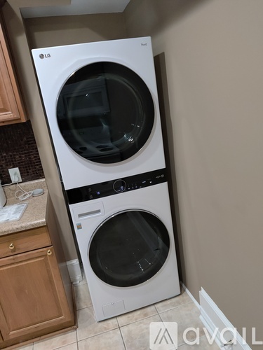 A white LG front load washing machine in a kitchen.